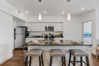 Modern kitchen area with large island and bar stools